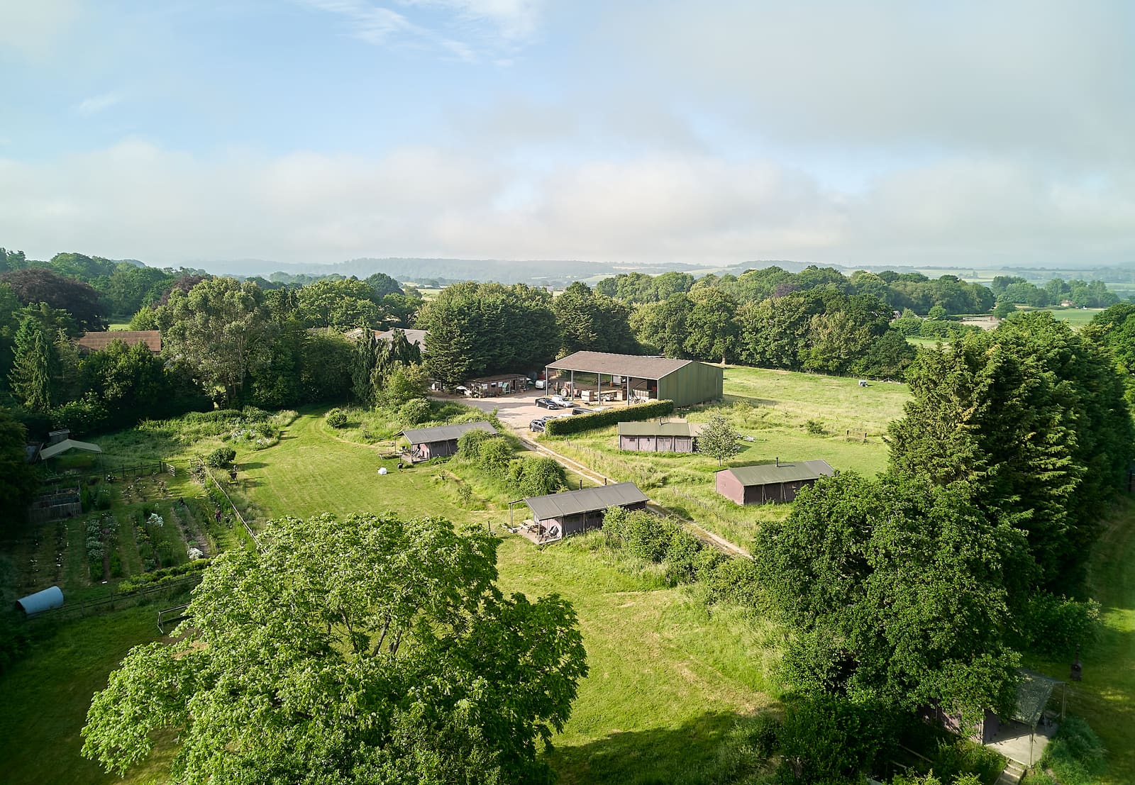 Aerial view of the farm, barn and pitches in the South Downs
